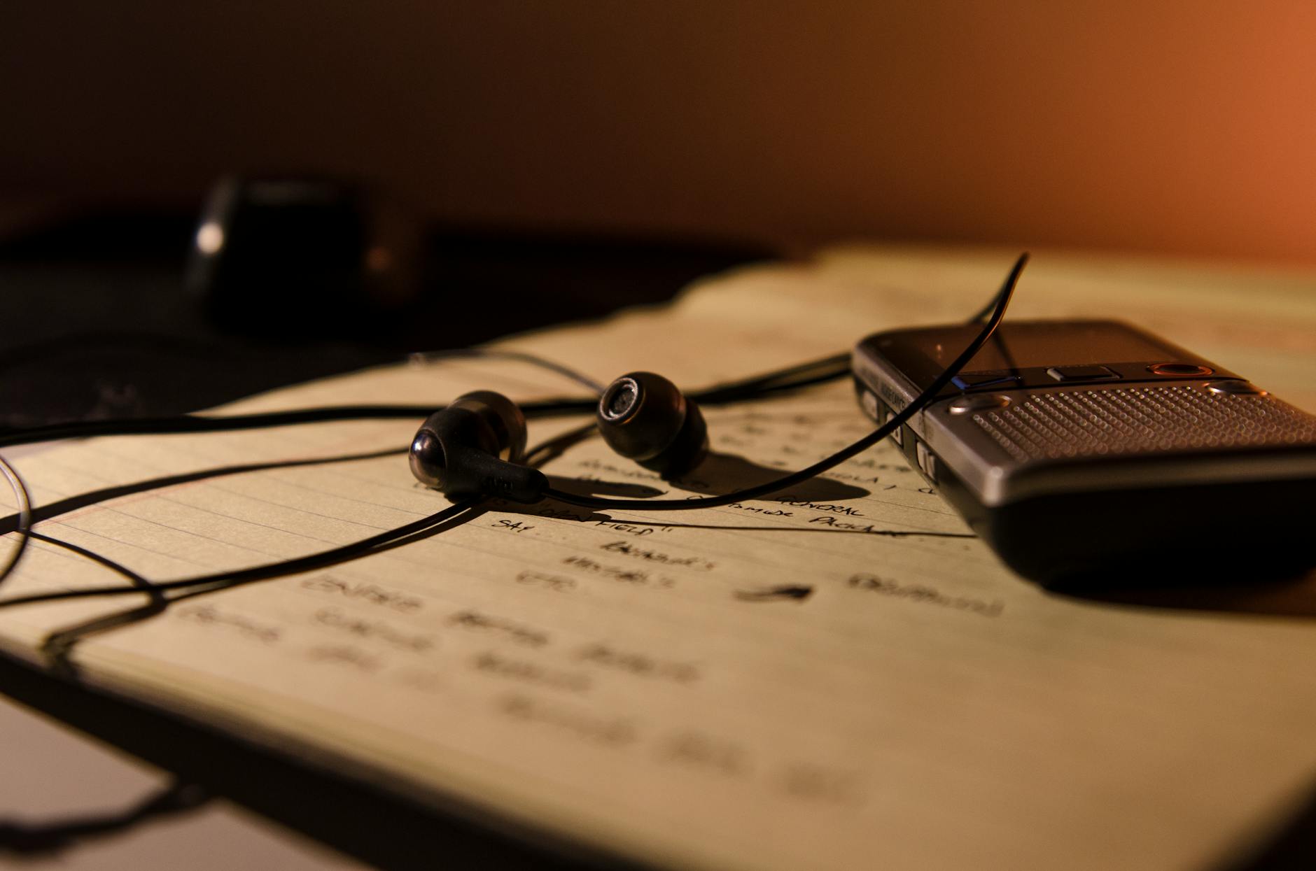 recorder with earphones on a notebook