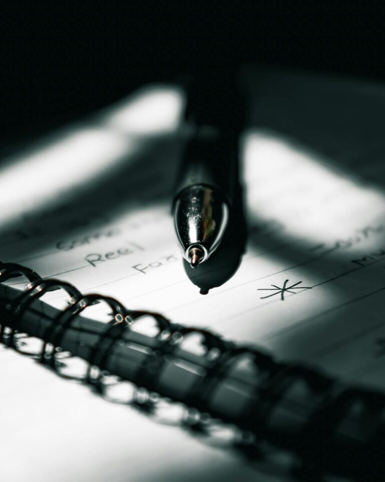 close up photo of a pen on top of notebook
