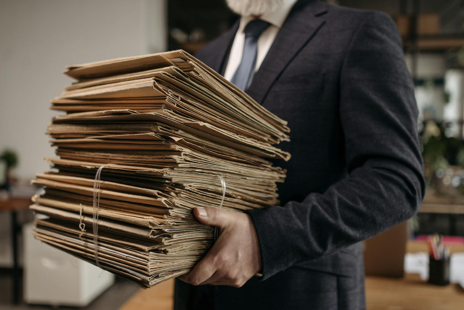 close up shot of a person carrying document folders